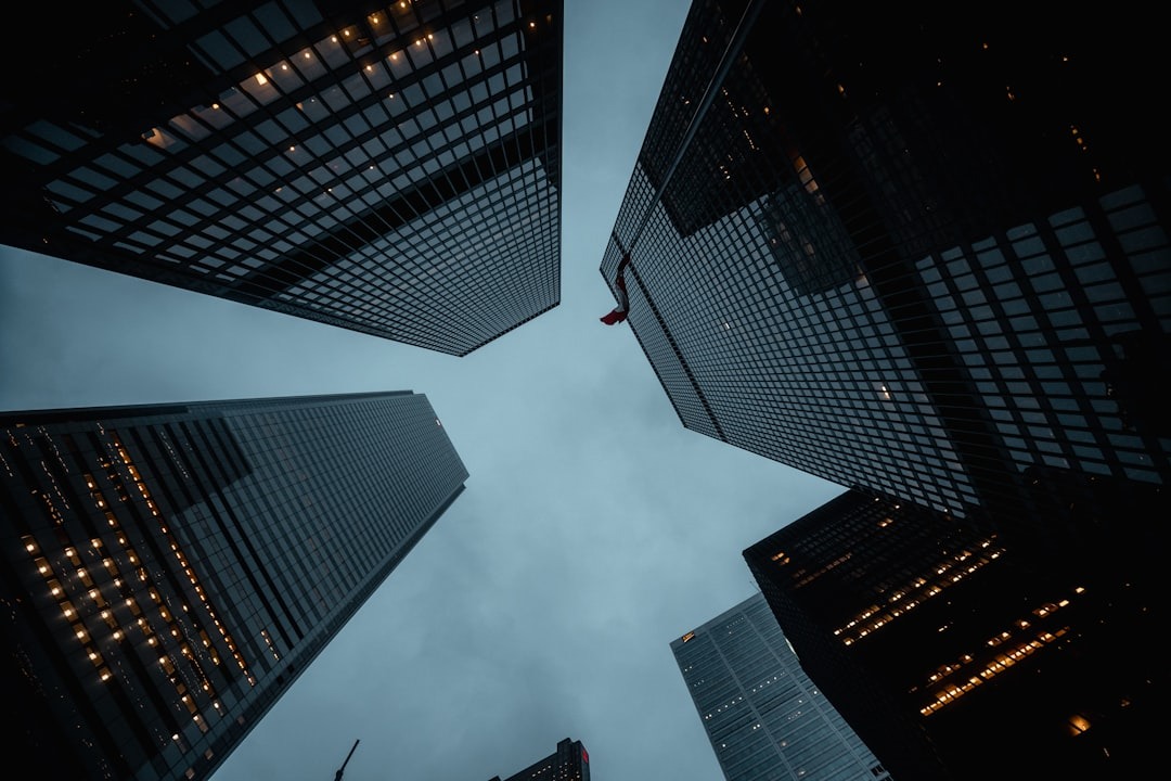 Looking up at five skyscrapers on a cloudy day.